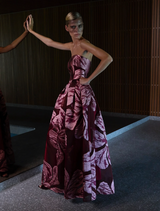 Strapless gown featuring a vibrant floral print, showcasing a blend of colors and elegant design.
