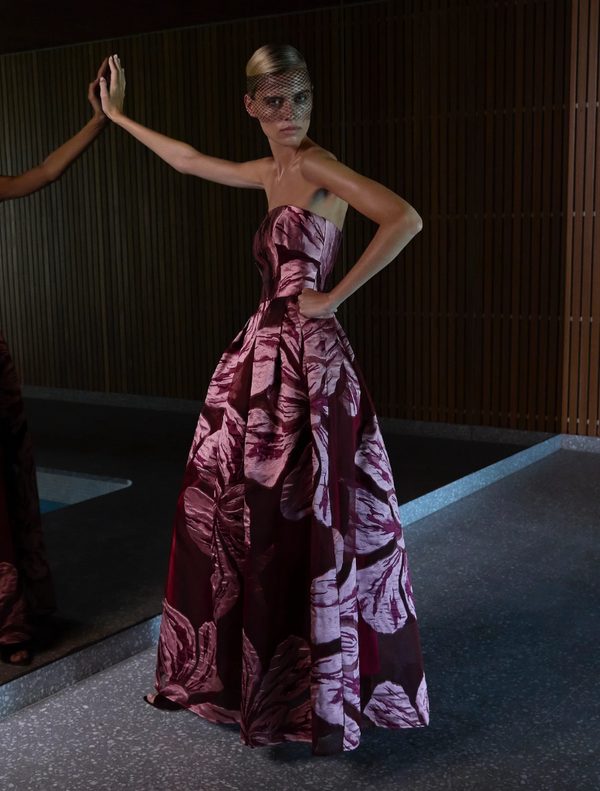 Strapless gown featuring a vibrant floral print, showcasing a blend of colors and elegant design.
