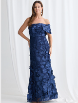 Navy Bellami Maxi Dress by Trellis Lane, featuring 3D floral fabric, off-shoulder sleeves, and an asymmetric hem.
