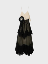 Timeless black and white dress with delicate ruffles, pointed cutouts, and a removable belt, embodying modern romance and elegance.