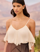 Flowing black and white dress with romantic ruffles, pointed cutouts, and a removable tie-dye flower belt for a chic appearance.