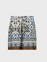 Bermuda pants featuring a black print with decorative ornaments, ideal for casual or semi-formal wear.