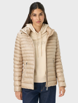 Beige Bern quilted jacket displayed on a hanger, showcasing its textured fabric and stylish design.