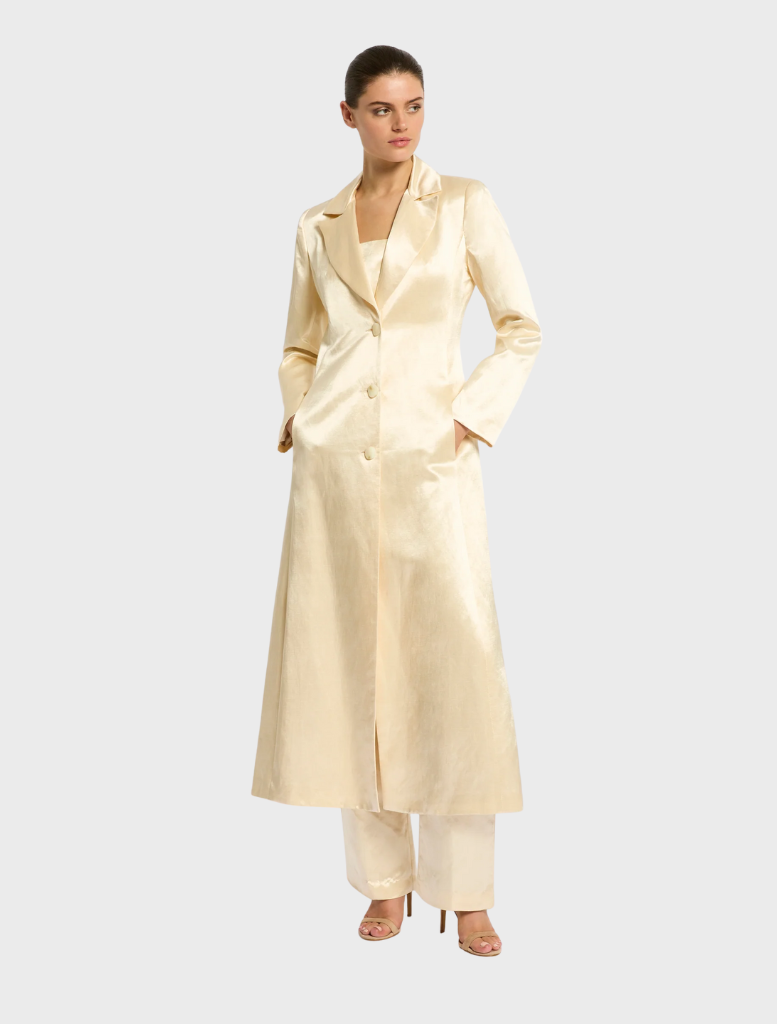  A stylish buttermilk-colored trench coat displayed on a mannequin against a neutral background.