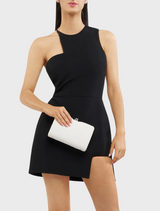 A woman in a black dress is seen holding a white Birdie Textural Handle Bag, adding a chic touch to her ensemble.