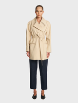 Elegant bisque wrap trench coat with a belted design and long sleeves, ideal for stylish layering during fall.