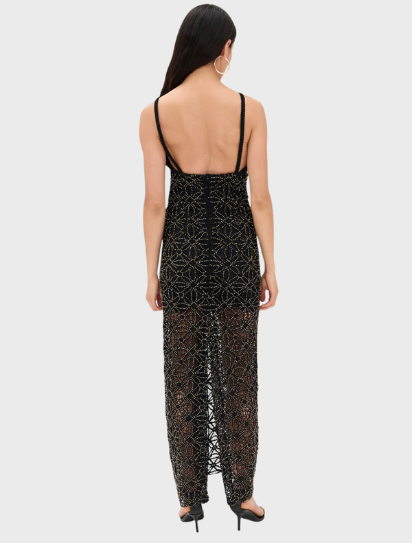 Elegant black Anet Dress hanging on a rack, showcasing its simple yet stylish design.