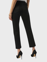 Black ankle-length slim jeans arranged neatly for display.