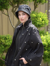 Black Baby I'm Back Jacket laid flat, emphasizing its trendy style and quality material.
