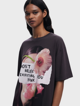 A woman wearing a t-shirt with the phrase "don't live everything to" promotes a thoughtful and inspiring message.