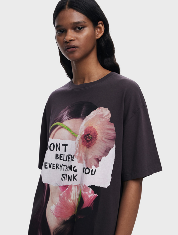 A woman wearing a t-shirt with the phrase "don't live everything to" promotes a thoughtful and inspiring message.