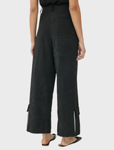 Black Brams pants arranged neatly, emphasizing their modern cut and fabric quality.
