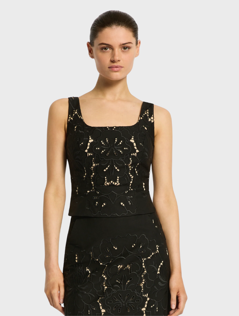 Stylish black crop top, the Colette Bustier, featuring beautiful lace detailing for a trendy appearance.