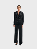 Elegant black drape top featuring soft, flowing fabric for a stylish look.