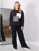 Elegant black trousers with decorative trim, perfect for adding a touch of sophistication to any outfit.