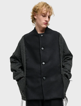 Black oversized jacket for all genders, crafted from wool-blend brocade and flannel, featuring two pockets and cord embellishments.