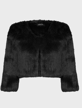 Elegant black fur bolero draped on a mannequin, highlighting its soft texture and stylish silhouette.