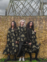 Shine Of The Times cardigan in black and gold, highlighting a chic design with a shimmering finish.