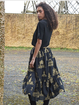 Stylish black and gold skirt featuring a whimsical pattern, perfect for adding flair to casual or formal ensembles.