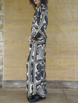 Elegant black kick pleat pants designed for a sophisticated look, featuring a unique pleat for enhanced style.