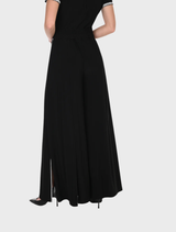 A pair of black knit pants laid flat, highlighting their comfortable fabric and relaxed fit.