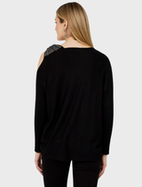 A black knit top shown on a mannequin, highlighting its comfortable fit and versatile style for everyday outfits.