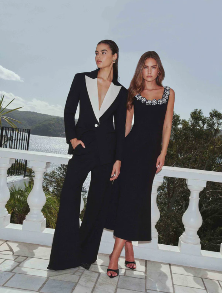 A close-up of a black and white wool suit, highlighting the fabric's texture and elegant tailoring.