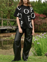 A pair of black Lock, Stock & Barrel pants laid flat, highlighting their stylish cut and fabric texture.