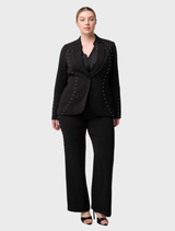Marcela Pearl's black blazer showcases embellishments, offering a chic and polished appearance for any outfit.
