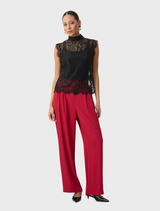 Fitted black floral lace top with scalloped cap sleeves, mock neckline, and an invisible back zipper for a delicate look.