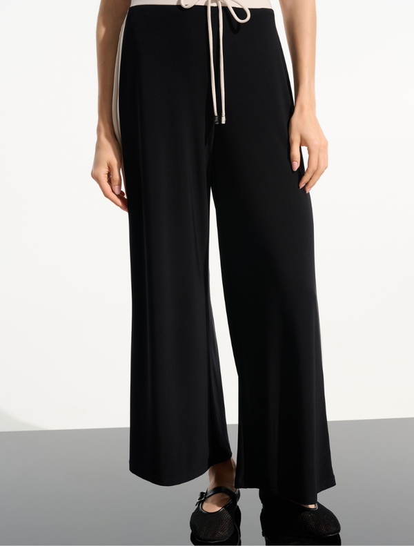 Stylish black pants highlighted with moonstone details, perfect for versatile outfit combinations.