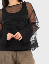 Black Pacos top displayed, illustrating its contemporary design and smooth fabric finish.