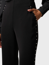 Elegant black stretch pants by Marcela Pearl, adorned with embellishments for a chic appearance.