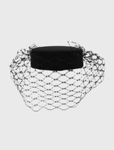 Morgan & Taylor's black Zahra Pillbox Hat, a classic fascinator with structured shape and veiling, suitable for any formal outfit.