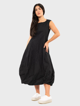 Fashionable black poplin dress featuring a striking print, suitable for both day and evening wear.