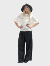 Black trousers featuring a rusty appearance, emphasizing their vintage aesthetic and rugged charm.
