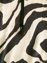 Black and stone dress featuring a modern design, suitable for various occasions. Elegant and stylish for any wardrobe.