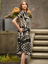 Elegant black and stone dress with a contemporary silhouette, perfect for both casual and formal events.