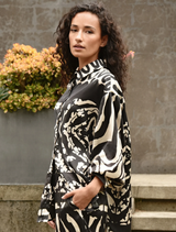 A black and stone casual shirt laid flat, featuring a simple, stylish design suitable for everyday wear.