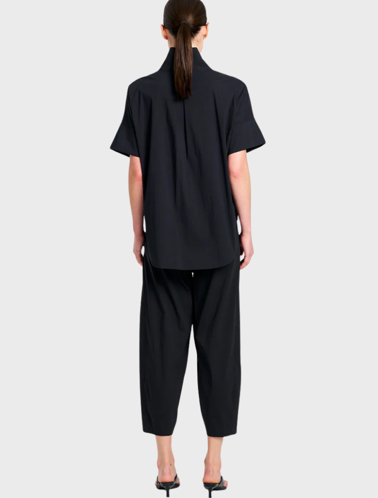 Sleek black cross pants presented, emphasizing their tailored fit and suitability for both casual and professional settings.