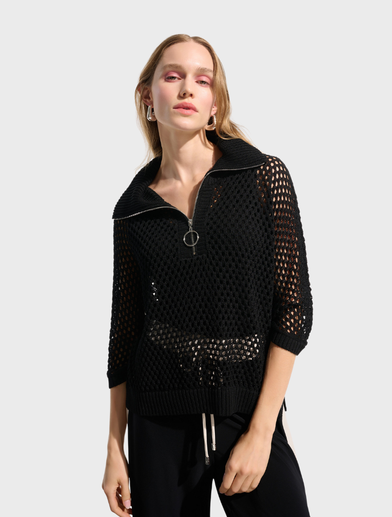 A black top hanging on a hanger, featuring a classic and versatile style.