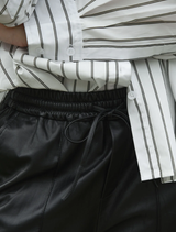 Black Track-Tic Pant folded neatly, featuring a lightweight material perfect for active lifestyles and comfort.