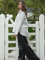 Black Track-Tic Pant laid flat, highlighting its modern cut and fabric ideal for sports and everyday activities.