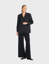 Sleek black utility blazer with a modern design, equipped with pockets for practicality and style.