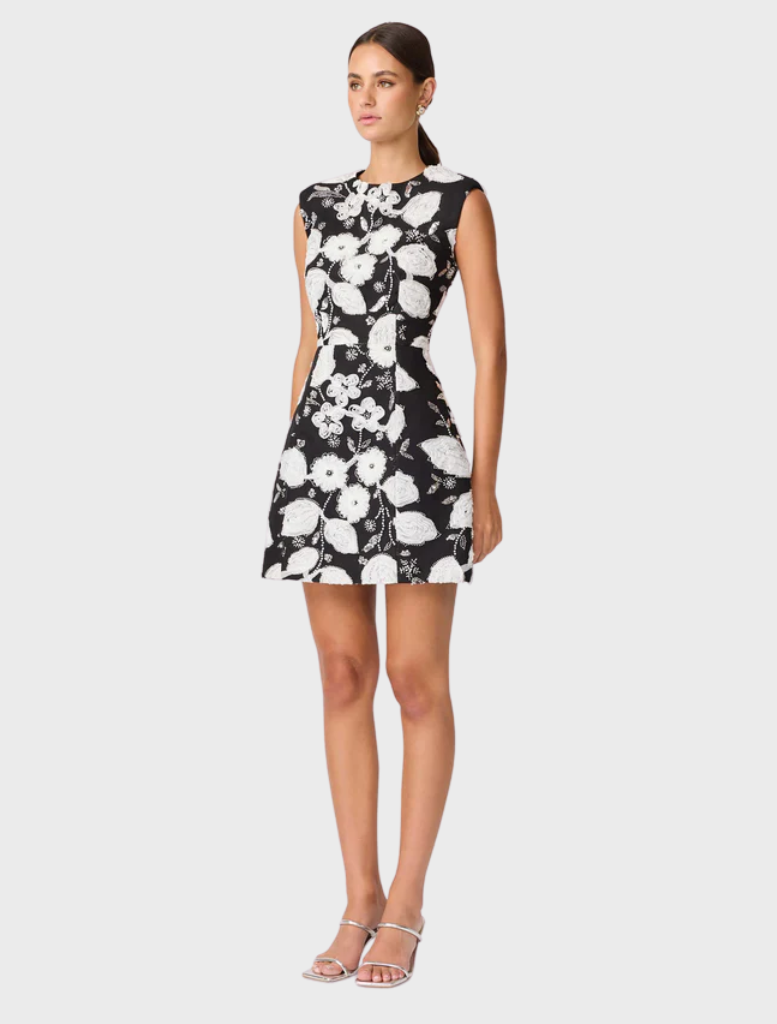 A black and white dress with floral motifs, artfully designed to evoke the look of a blossoming flower.