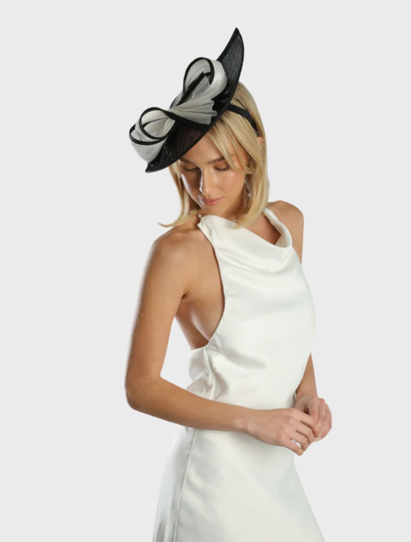Stylish black and white Xanthia fascinator with delicate embellishments, ideal for enhancing formal attire.
