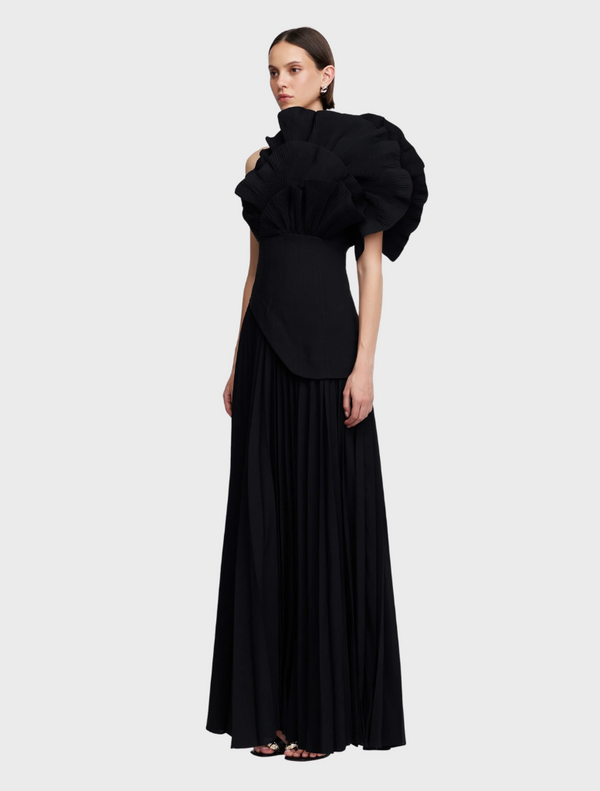 Black Whittington gown draped elegantly, highlighting its sleek silhouette and luxurious fabric texture.
