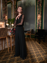 Elegant black wide leg jumpsuit, model 263723, designed for comfort and style with a flowing silhouette.