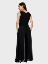 A pair of black woven pants laid flat, highlighting their texture and tailored fit for a stylish look.