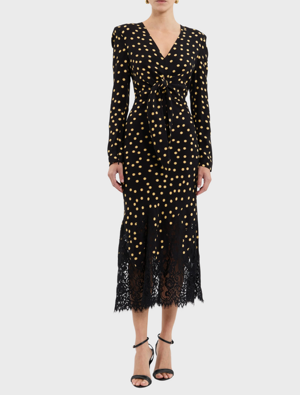  A stylish black and gold polka dot dress featuring delicate lace trim.